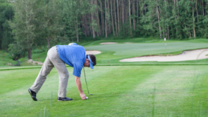 a man fixing the golf ball