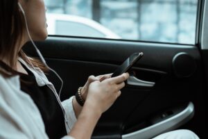 girl in a headset inside a car listening to podcast