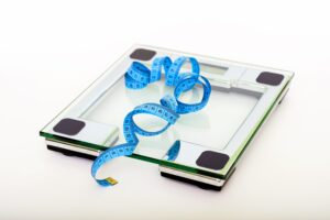 Weighing scale and measuring tape in Cut the fat Podcast