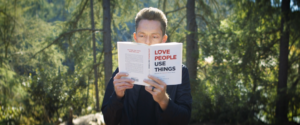 the minimalists podcast host is reading a book